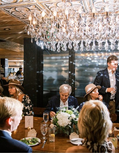 couple greets guests at rehearsal dinner at the slope room in vail colorado